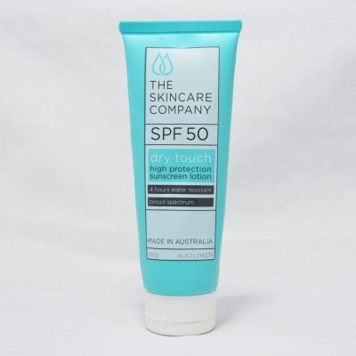 A blue bottle of Dry Touch SPF 50 Sunscreen